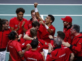 Canada's Felix Auger Aliassime, centre, celebrates with teammate after defeating Australia's Alex de Minaur during the final Davis Cup tennis match between Australia and Canada in Malaga, Spain, Sunday, Nov. 27, 2022. Defending champion Canada will face Italy, Sweden and Chile in the group stage of the 2023 Davis Cup.