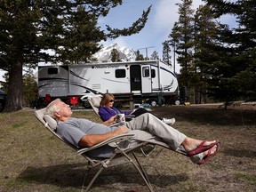 Kathryn and Les Olaski relax in the warm sunshine while camping at Tunnel Mountain campground in Banff on May 14, 2014.