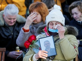 Relatives react during a commemorative ceremony marking the second anniversary of the Ukraine International Airlines flight PS752 downing in Iranian airspace, in Kyiv, Ukraine on Jan. 8, 2022.