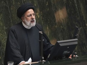 FILE - Iranian President Ebrahim Raisi addresses lawmakers while defending his next year's budget bill at the parliament in Tehran, Iran, Sunday, Jan. 22, 2023. Raisi on Wednesday, March 1, ordered authorities to investigate a series of incidents in which noxious fumes have sickened students at girls' schools, which some officials suspect are attacks targeting women's education.