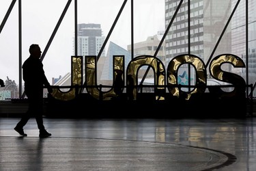 A pedestrian makes their way past a Junos Award sign in Ford Hall at Rogers Place in Edmonton, Friday March 10, 2023.