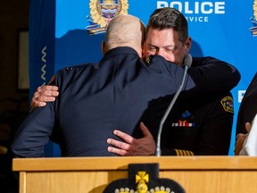 Police Chief Dale McFee hugs Fire Chief Joe Zatylny   after a news conference dealing with two officers that were killed on Thursday, March 16, 2023, while responding to a call in the city's northwest. The officers were identified as Const. Travis Jordan, 35 and Const. Brett Ryan, 30. Jordan was an 8.5-year veteran of the Edmonton Police Service, while Ryan was with the EPS for 5.5 years.