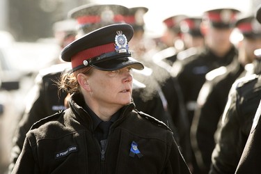 Edmonton Police Service members and recruits march to the Serenity Funeral Home as they wait for a procession carrying the bodies of Const. Travis Jordan and Const. Brett Ryan to arrive, in Edmonton Tuesday March 21, 2023.