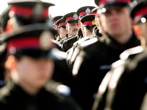 Edmonton Police Service recruits march to the Serenity Funeral Home as they wait for a procession carrying the bodies of Const. Travis Jordan and Const. Brett Ryan to arrive, in Edmonton Tuesday March 21, 2023.