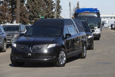 A procession arrives with the bodies of Const. Travis Jordan and Const. Brett Ryan at the Serenity Funeral Home, in Edmonton Tuesday March 21, 2023.