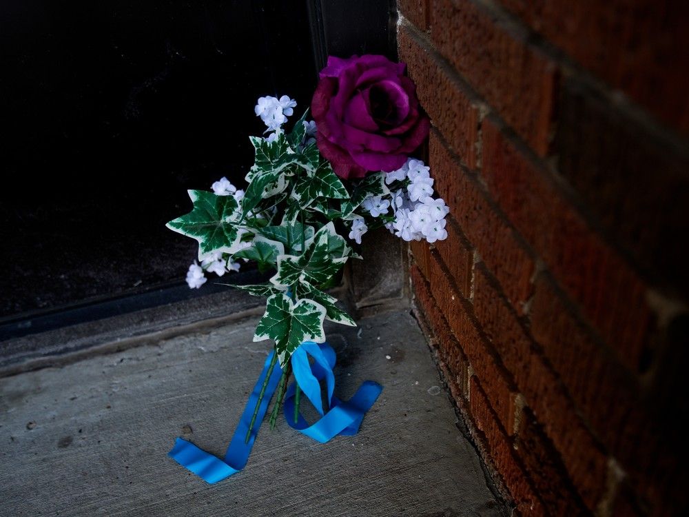 Flowers lay outside the front door of the Baywood Apartment complex, 11445 132 St., on Monday March 20, 2023, following the shooting deaths of Const. Travis Jordan and Const. Brett Ryan, in Edmonton last Thursday.