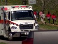 Children run past an ambulance near the Covenant School after a shooting in Nashville, Tennessee, U.S. March 27, 2023 in a still image from video.