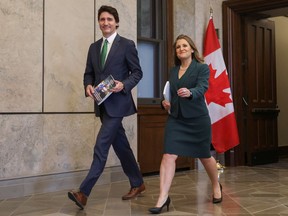 Prime Minister Justin Trudeau and Finance Minister Chrystia Freeland walk holding the 2023-24 budget, on Parliament Hill in Ottawa, March 28.