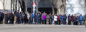 People line the street as police officers march from the Alberta Legislature to Rogers Place for the regimental funeral for two EPS officers, constables Brett Ryan and Travis Jordan, who were killed in the line of duty on March 16, 2023. Taken on Monday, March 27, 2023 in Edmonton.