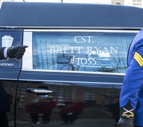 A hearse carrying the body of  EPS officer, constable Brett Ryan  leaves the Alberta Legislature on route to Rogers Place for a regimental funeral. Constables Brett Ryan and Travis Jordan were killed in the line of duty on March 16, 2023. Taken on Monday, March 27, 2023 in Edmonton.
