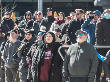 People watch the regimental funeral in Ice District Plaza on Monday, March 27, 2023, for Edmonton Police Service constables Travis Jordan and Brett Ryan who were killed in the line of duty.