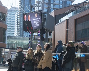 People watch the regimental funeral in Ice District Plaza on March 27, 2023. The service was for Edmonton Police Service constables Travis Jordan and Brett Ryan killed in the line of duty.