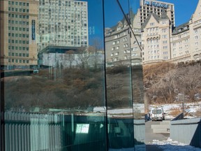 Clean up crews were on the river valley look out below the Funicular on March 3, 2023, to replace glass shattered after Edmonton Police shot a man with a gun in the area.