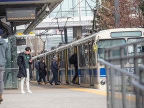 Transit riders board an LRT train on March 15, 2023 in Edmonton.