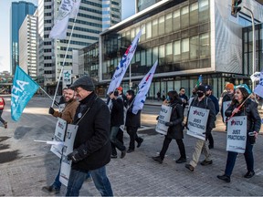 About 40 people marched on city hall hall on March 3, 2023 in support of Edmonton Transit's DATS operators. The city of Edmonton is paying DATS drivers  less than they pay conventional transit operators.  Photo by Shaughn Butts-Postmedia