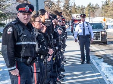 Police officers honoured their fallen colleagues as they were transported to the medical examiners office by an escort of police, fire and EMS on March 16, 2023 in Edmonton. Two EPS members were killed in the line of duty after responding to a domestic call earlier in the day.