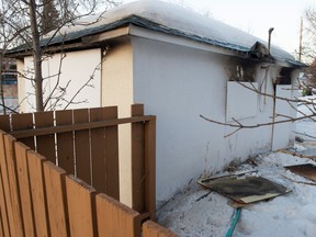 Fire fighters discovered a body in a detached garage after a fire was extinguished in a boarded up property on March 18, 2023 in Edmonton. Photo by Shaughn Butts-Postmedia