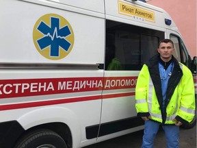 A Ukranian paramedic with one of the high-visibility reflective vests donated to a charity run by an Edmonton peace officer by the Town of Jasper.