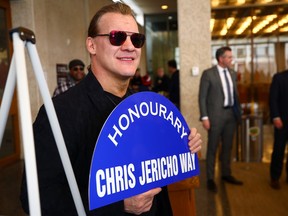 Wrestling legend Chris Jericho shows off an honour he received from Mayor Scott Gillingham at city hall in Winnipeg on March 15, 2023. Wordsworth Way between Browning Boulevard and Westwood Drive will bear the name of Jericho, who is also a musician, actor and author and was in town for the first All Elite Wrestling card in Winnipeg on Thursday night. Jericho hasn't wrestled in his hometown since 2009, and will be part of a three-on-three match with another Winnipegger, Kenny Omega, part of the opposition.