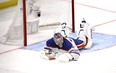 Edmonton Oilers goalie Stuart Skinner lies on the ice after giving up a goal to Los Angeles Kings' Phillip Danault.