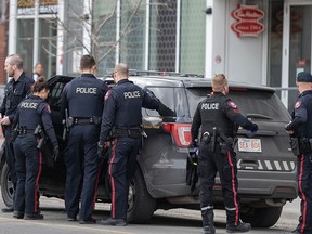 Calgary police officers take a suspect of multiple stabbings into custody in East Village on Monday, April 3, 2023.