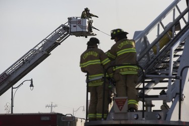 Firefighter work at a fire at Times Square XXX, 15539 Stony Plain Rd., in Edmonton, Friday, April 14, 2023.