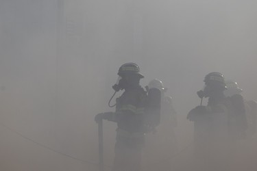 Firefighter work at a fire at Times Square XXX, 15539 Stony Plain Rd., in Edmonton, Friday, April 14, 2023.