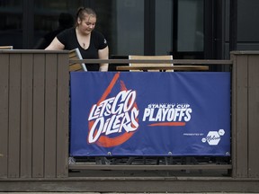 Staff at The Cabin Pub + Party, 11606 Jasper Ave., set up the patio ahead of the Edmonton Oilers and Los Angeles Kings NHL playoff game in Edmonton, Wednesday April 19, 2023.