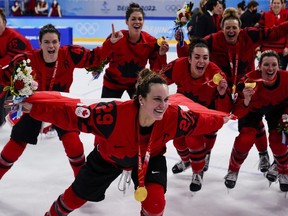 Canada's Marie-Philip Poulin (29) celebrates with her gold medal after the women's gold medal hockey game at the 2022 Winter Olympics in Beijing, Thursday, Feb. 17, 2022. The Canadian women chase a third straight world title starting Wednesday against Switzerland in Brampton, Ont.