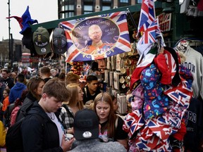 Someone's ready: People browse coronation souvenir items for sale outside the Houses of Parliament in London this week.