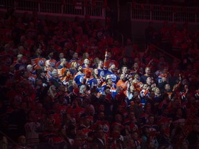 Fans of the Edmonton Oilers, sing the national anthem prior to the game against the Los Angeles Kings at Rogers Place in Edmonton on April 19, 2023.