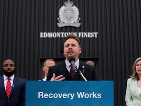 Mental Health and Addiction Minister Nicholas Milliken announces new investments in public safety and addiction recovery during a news conference outside the Edmonton Police Service southwest division office on April 19, 2023.
