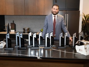 Charles Fay, vice-president Jayman Built Edmonton division, poses for a photo with some of the 12 awards won at the Canadian Home Builders' Association-Edmonton Region's Awards of Excellence in Housing.