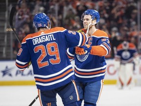Edmonton Oilers' Connor McDavid (97) and Leon Draisaitl (29) celebrate a goal against the Arizona Coyotes during overtime NHL action in Edmonton on Wednesday March 22, 2023.
