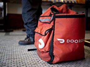 A food delivery bag for DoorDash Inc. on the floor of a restaurant. Half of Canadians expect to take on gig work in retirement.