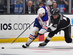 Los Angeles Kings center Anze Kopitar (11) moves in for the puck against Edmonton Oilers center Leon Draisaitl (29) during the first period in game four of the first round of the 2023 Stanley Cup Playoffs at Crypto.com Arena.