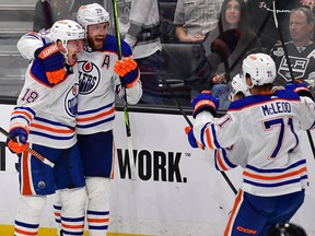 Edmonton Oilers left wing Zach Hyman (18) celebrates his goal scored against the Los Angeles Kings with center Leon Draisaitl (29) and center Ryan McLeod (71) during overtime in game four of the first round of the 2023 Stanley Cup Playoffs at Crypto.com Arena. Mandatory Credit: Gary A. Vasquez-USA TODAY Sports