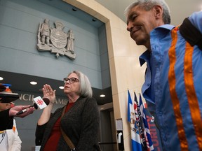 Homelessness researchers Marlene Mulder, left, and Jerry McFeeters speak to the media outside council chambers at Edmonton city hall on Tuesday, April 11, 2023.