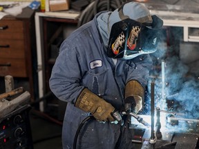 A worker welds a steel girder at a facility in British Columbia.