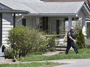 A Louisville Metro Police officer walks outside of the home of the suspected shooter in the Camp Taylor neighborhood in Louisville, Ky., Monday, April 10, 2023. Police say a 23-year-old armed with a rifle opened fire at his Louisville workplace, the Old National Bank in downtown Louisville, killing and wounding several, and was killed by police responding to the shooting.