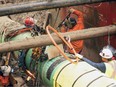 Workers prepare pipe during construction on the Trans Mountain pipeline expansion project in B.C.'s Fraser Valley.