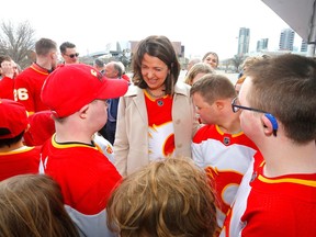 Premier Danielle Smith with Flames players and Flames Foundation members during the announcement of the future Event Centre in Calgary on Tuesday, April 25, 2023.
