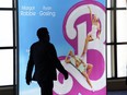 An attendee walks past an advertisement for the upcoming film "Barbie" on the opening day of CinemaCon 2023, the official convention of the National Association of Theatre Owners (NATO) at Caesars Palace, Monday, April 24, 2023, in Las Vegas. The four-day convention runs through Thursday.