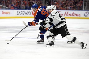 The Edmonton Oilers' Connor McDavid (97) battles the Los Angeles Kings' Carl Grundstrom (91) and Rasmus Kupari (89) during first period NHL playoff action at Rogers Place in Edmonton, Tuesday April 25, 2023.