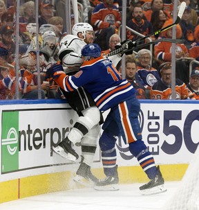 The Edmonton Oilers' Zach Hyman (18) checks the Los Angeles Kings' Vladislav Gavrikov (84) during third period NHL playoff action at Rogers Place in Edmonton, Tuesday April 25, 2023. The Oilers won 6-3.