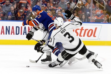 The Edmonton Oilers' Connor McDavid (97) battles the Los Angeles Kings' Vladislav Gavrikov (84) and Matt Roy (3) during third period NHL playoff action at Rogers Place in Edmonton, Tuesday April 25, 2023. The Oilers won 6-3.