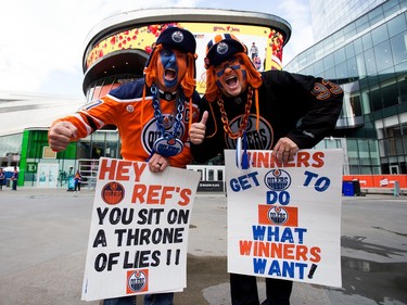 Edmonton Oilers fans Kurt Kellgren and Randall Johnston pose for a photo prior the start of the Edmonton Oilers and Los Angeles Kings Game 5 NHL playoff game outside Rogers Place in Edmonton, Tuesday April 25, 2023. Kellgren and Johnston were wearing an Oilers' colour version of the face paint Will Ferrell recently wore and holding modified quotes from his movies.