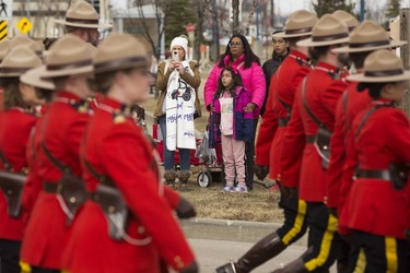 Members of the public watch the regimental funeral procession for Const. Harvinder Singh Dhami in in Sherwood Park, Alta., Thursday April 20, 2023.