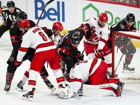 Carolina Hurricanes goaltender Frederik Andersen (31) covers the puck while taking on the Ottawa Senators during first period NHL hockey action in Ottawa on Monday, April 10, 2023.