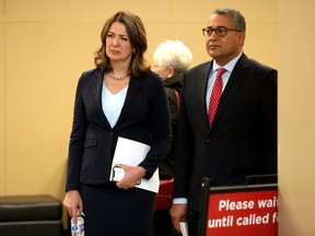 Danielle Smith, Leader of the Alberta UCP, and Dr. Raj Sherman, UCP Edmonton-Whitemud candidate, wait for the start of a press conference where Smith announced the party's public health guarantee on April 11.